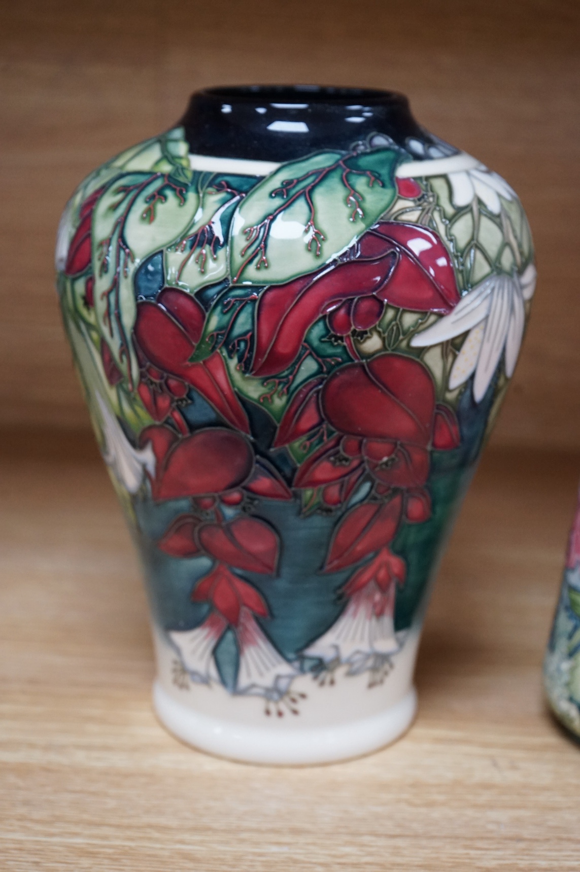 A Moorcroft ‘Nostalgia’ pattern vase together with a similar ‘Foxglove’ pattern ewer, 24.5cm. Condition - good, some crazing